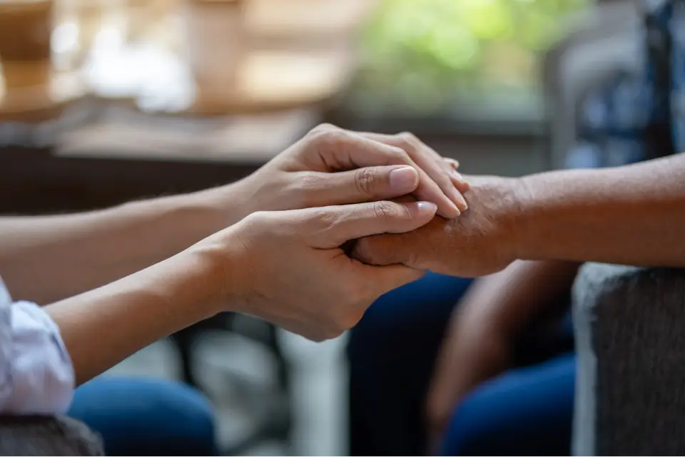 Two hands holding each other gently.